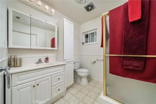 a bathroom with a toilet a sink and a mirror