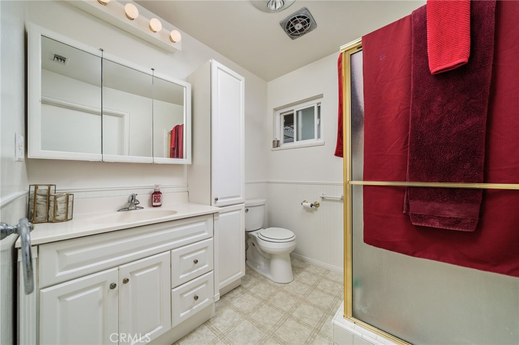 5035 Carlingford Avenue Riverside, CA 92504 - Photo 23 of 32 a bathroom with a toilet a sink and a mirror