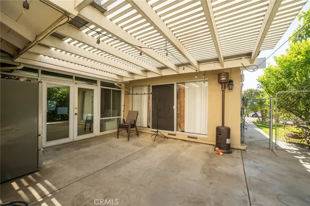 a view of a room with gym equipment and large windows