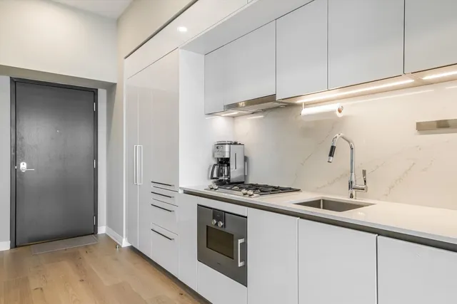 a kitchen with stainless steel appliances granite countertop a sink and a stove
