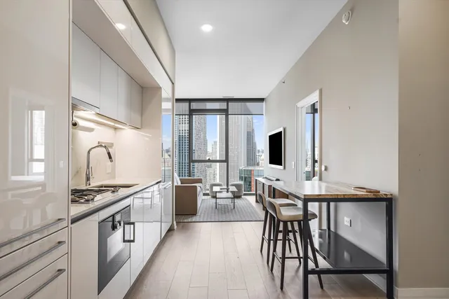 a kitchen with stainless steel appliances kitchen island granite countertop a stove a sink and a refrigerator