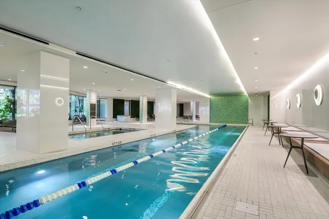 a room with pool table and windows