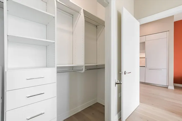 a view of walk in closet with empty racks