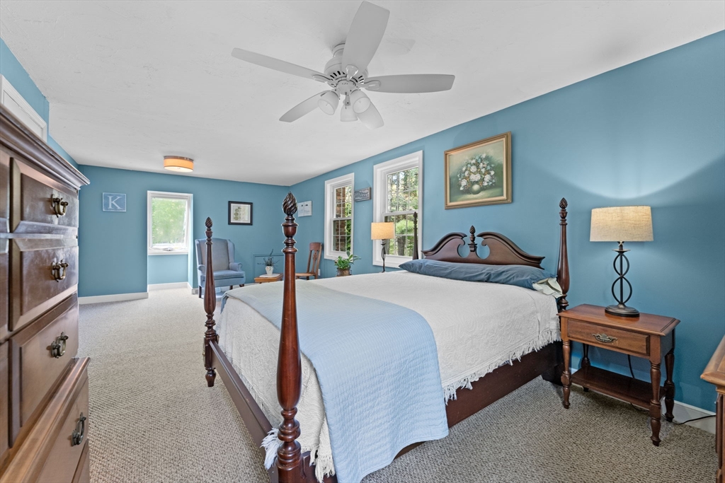 103 Maple Street Plympton, MA 02367 - Photo 23 of 41 a spacious bedroom with a bed and a chandelier