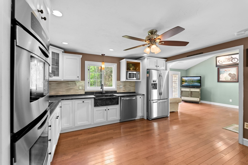 103 Maple Street Plympton, MA 02367 - Photo 4 of 41 a kitchen with stainless steel appliances a stove a refrigerator and a sink