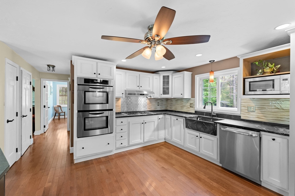 103 Maple Street Plympton, MA 02367 - Photo 6 of 41 a kitchen with stainless steel appliances a sink and wooden floors