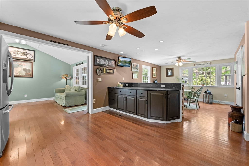 103 Maple Street Plympton, MA 02367 - Photo 7 of 41 a kitchen with stainless steel appliances granite countertop a stove top oven a sink with dining table and chairs