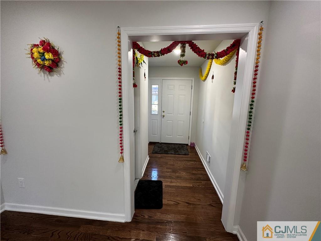 4102 Hana Road Edison, NJ 08817 - Photo 3 of 40 a view of a hallway with wooden floor and a glass door