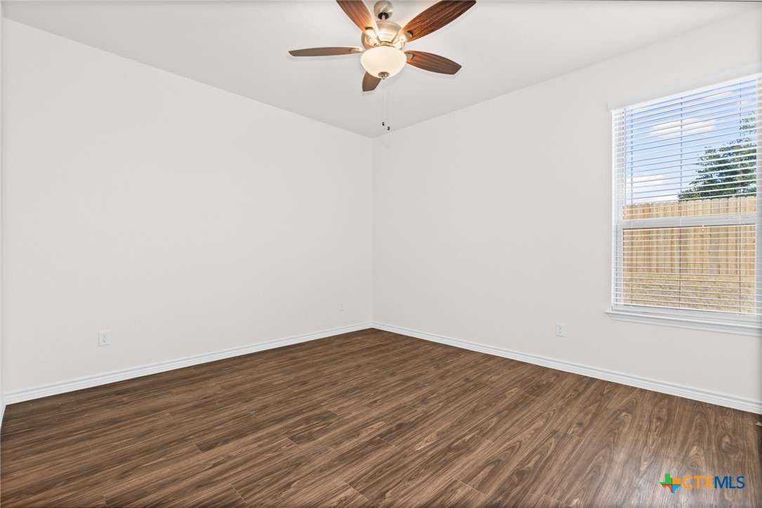 5112 Rose Gdn Loop Killeen, TX 76542 - Photo 19 of 20 an empty room with wooden floor fan and windows