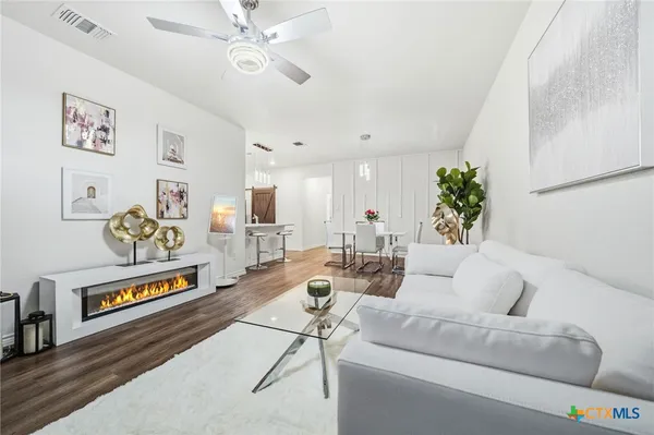 a living room with furniture and a potted plant