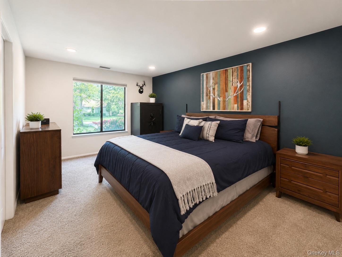 201 Birchwood Road, Unit 201 Coram, NY 11727 - Photo 12 of 27 a bedroom with a balcony a bed and a dresser next to a window