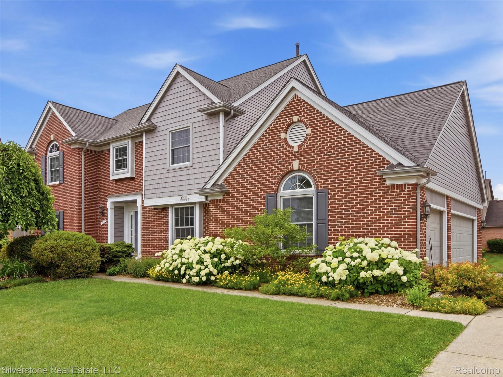 6577 Edith Court Troy, MI 48085 - Photo 2 of 61 Traditional brick and siding exterior with a two-car garage