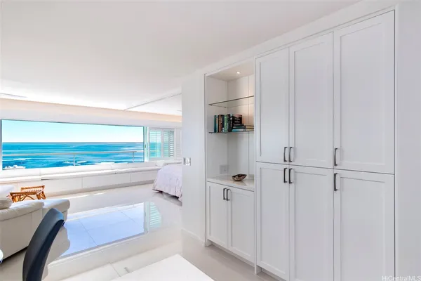 a room with a couch and a view of kitchen