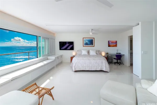 a bedroom with furniture and a large window