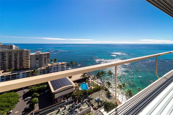 a view of a balcony with wooden chairs