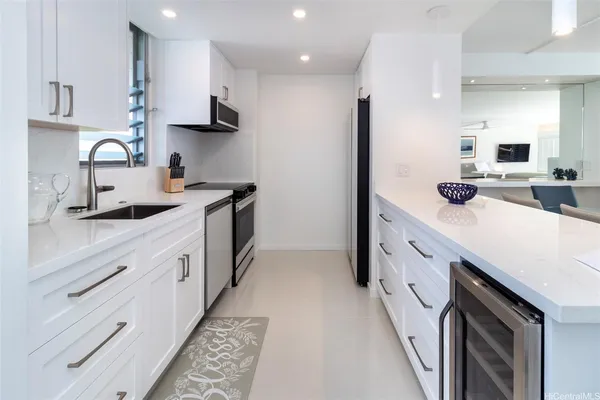 a kitchen with granite countertop a sink and cabinets