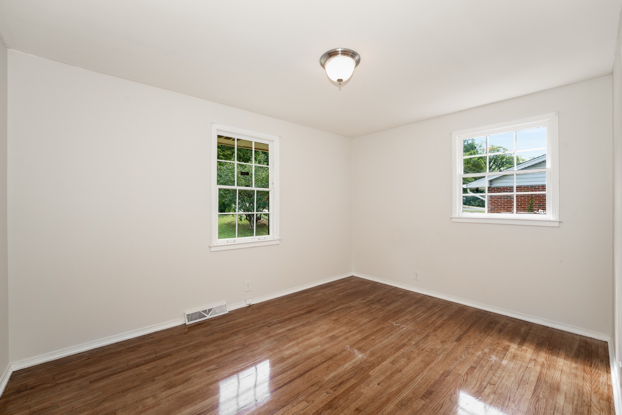 7979 Sawyer Brown Road Nashville, TN 37221 - Photo 18 of 25 a view of empty room with wooden floor and fan