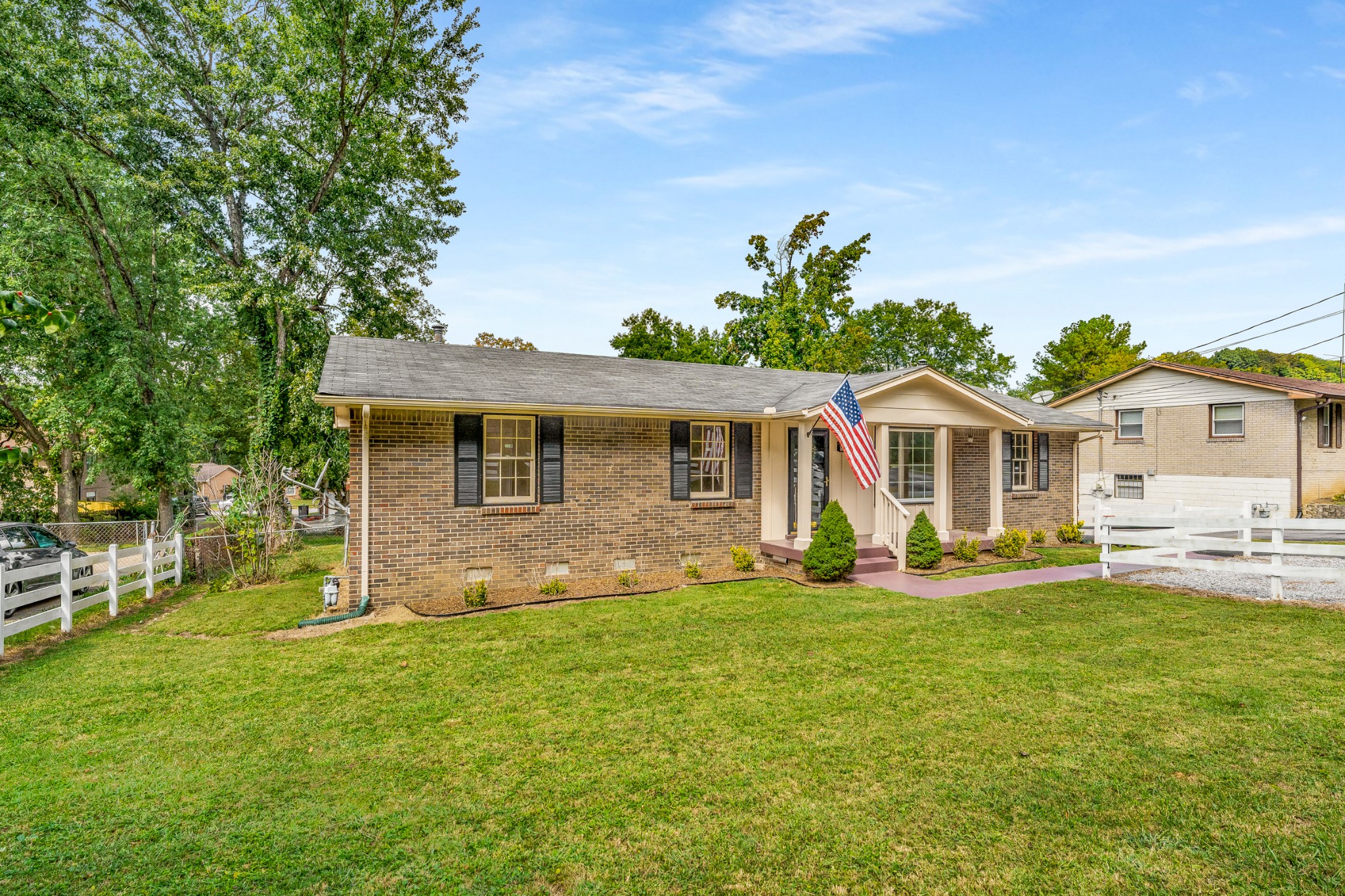 7979 Sawyer Brown Road Nashville, TN 37221 - Photo 25 of 25 a front view of a house with a yard and trees