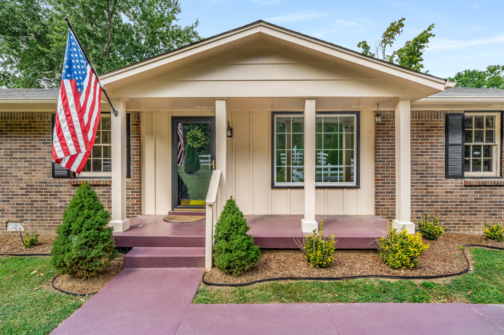 7979 Sawyer Brown Road Nashville, TN 37221 - Photo 5 of 25 a front view of a house with a yard