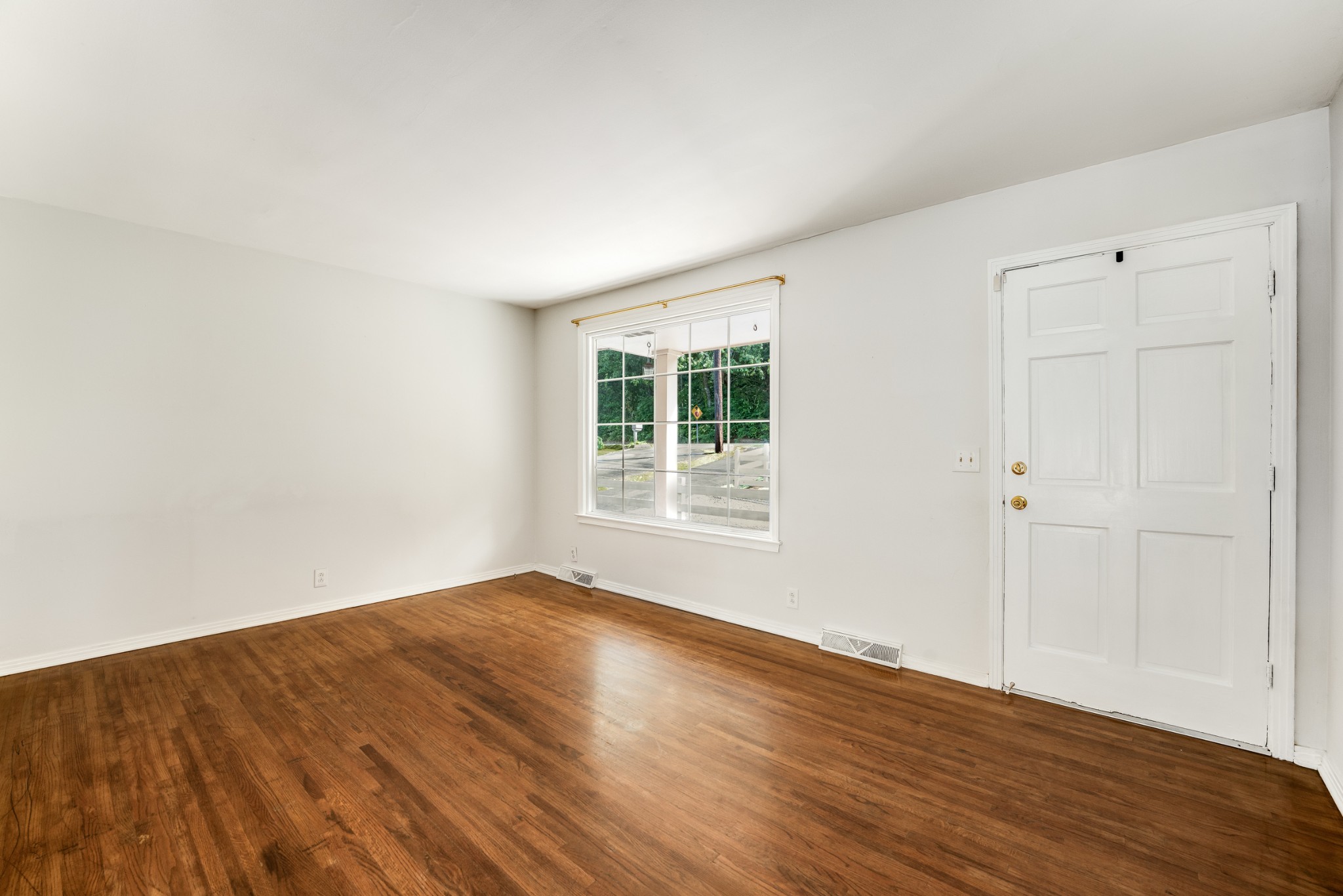 7979 Sawyer Brown Road Nashville, TN 37221 - Photo 6 of 25 a view of an empty room with wooden floor and a window