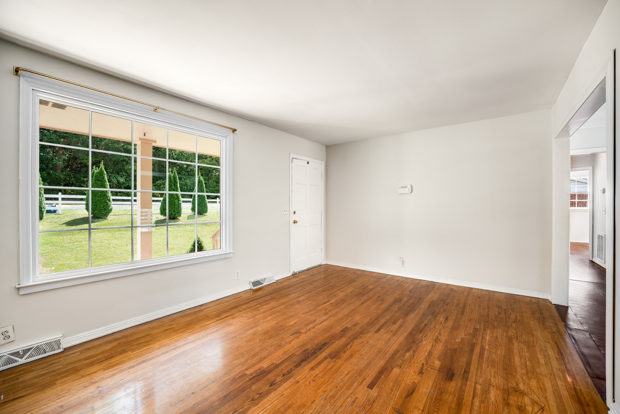 7979 Sawyer Brown Road Nashville, TN 37221 - Photo 7 of 25 a view of empty room with wooden floor and fan