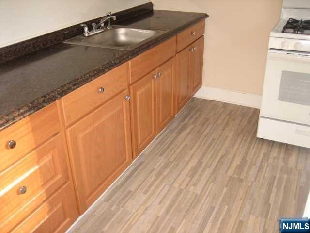 a view of a utility room with wooden floor
