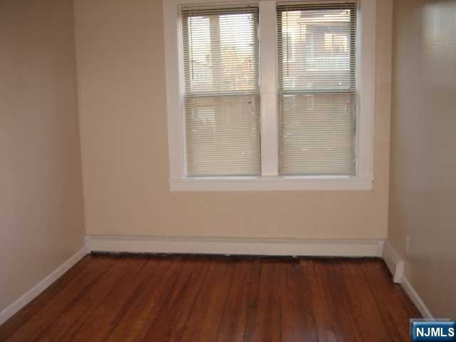 75 Barkley Avenue, Unit 4 Clifton, NJ 07011 - Photo 7 of 10 a view of a small space with wooden floor and a window