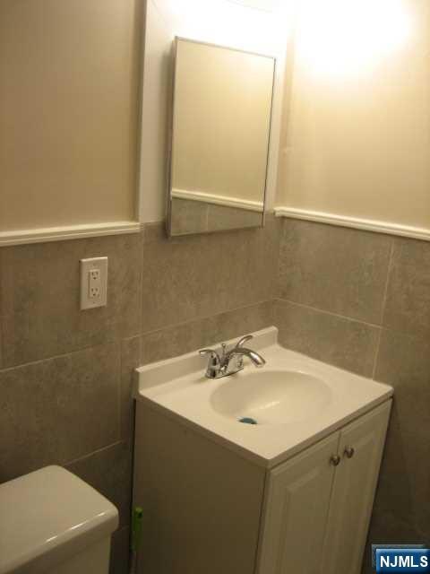 75 Barkley Avenue, Unit 4 Clifton, NJ 07011 - Photo 9 of 10 a bathroom with a sink and a mirror