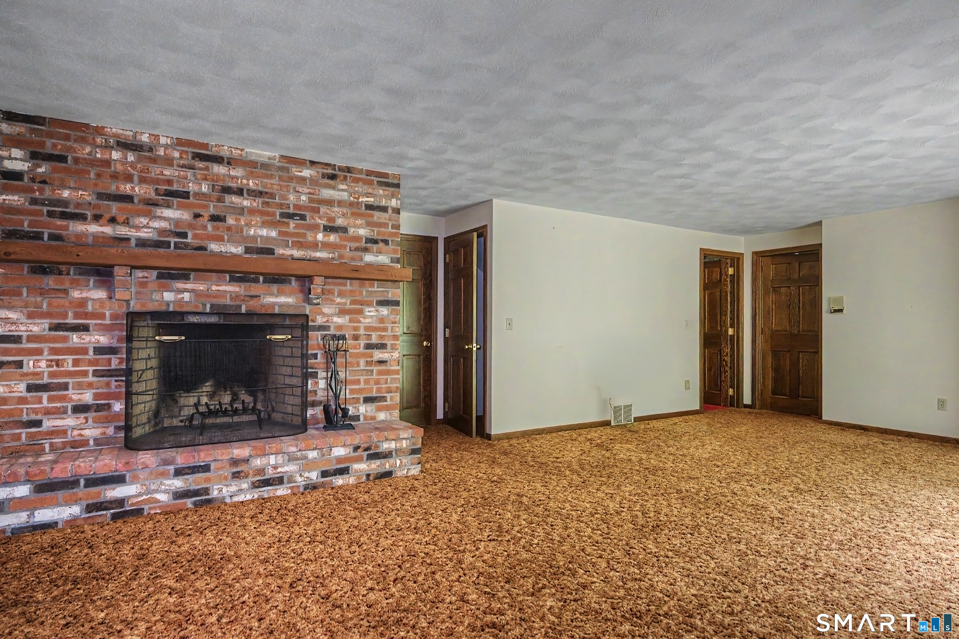 370 Hubbard Road Haddam, CT 06441 - Photo 30 of 39 Lower level playroom with wood burning fireplace and sliders to a slate patio.