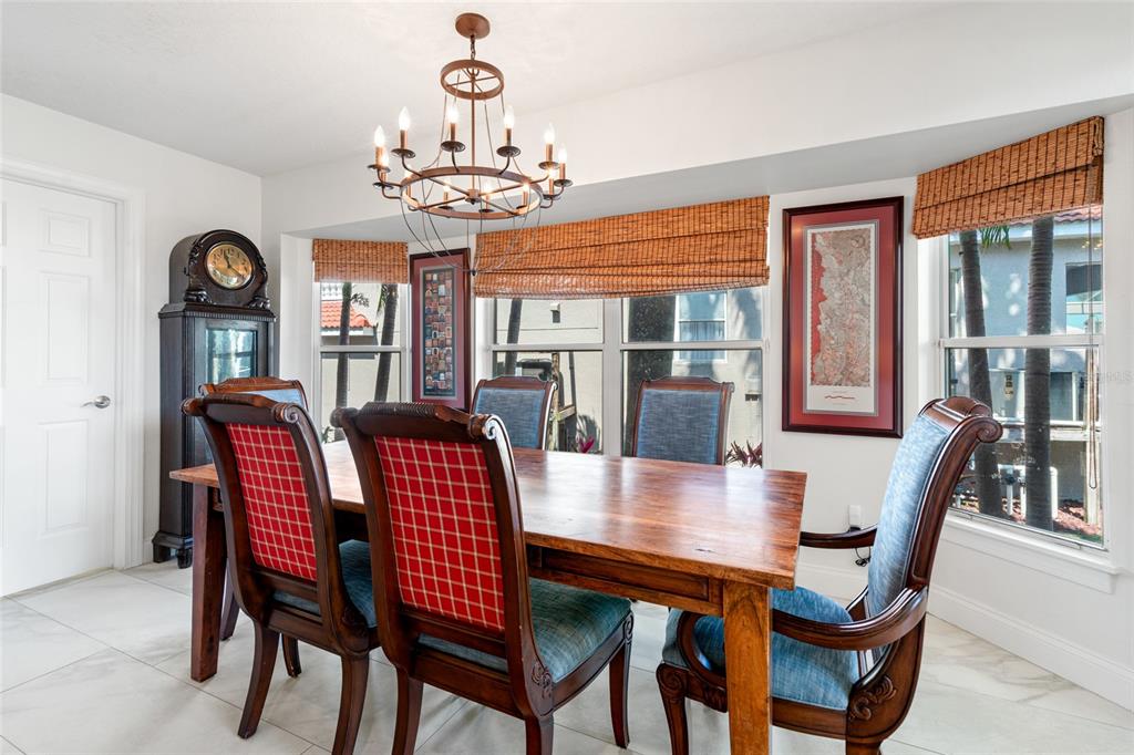 6315 Marbella Boulevard Apollo Beach, FL 33572 - Photo 14 of 83 a view of a dining room with furniture a chandelier and wooden floor