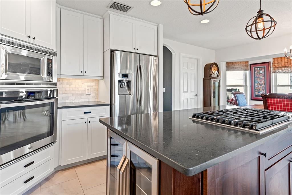 6315 Marbella Boulevard Apollo Beach, FL 33572 - Photo 18 of 83 a kitchen with stainless steel appliances granite countertop a stove a refrigerator and a microwave