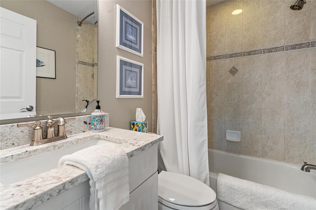 6315 Marbella Boulevard Apollo Beach, FL 33572 - Photo 24 of 83 a bathroom with a granite countertop sink toilet and shower