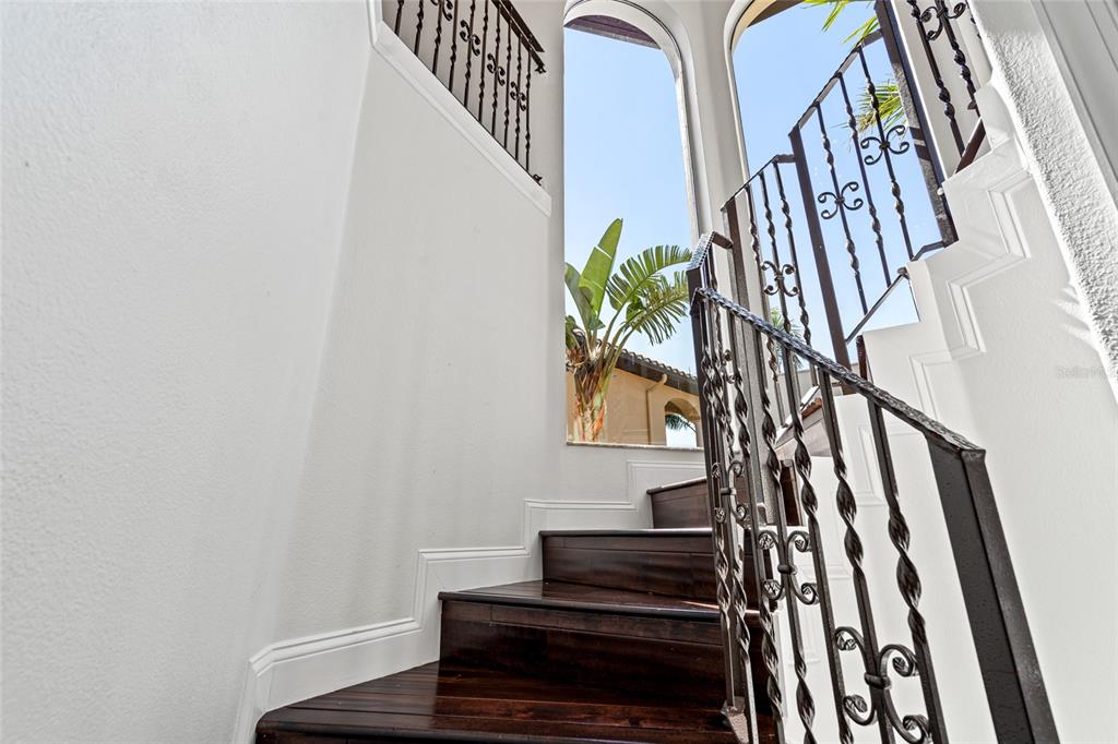 6315 Marbella Boulevard Apollo Beach, FL 33572 - Photo 26 of 83 a view of staircase with wooden floor and a potted plant