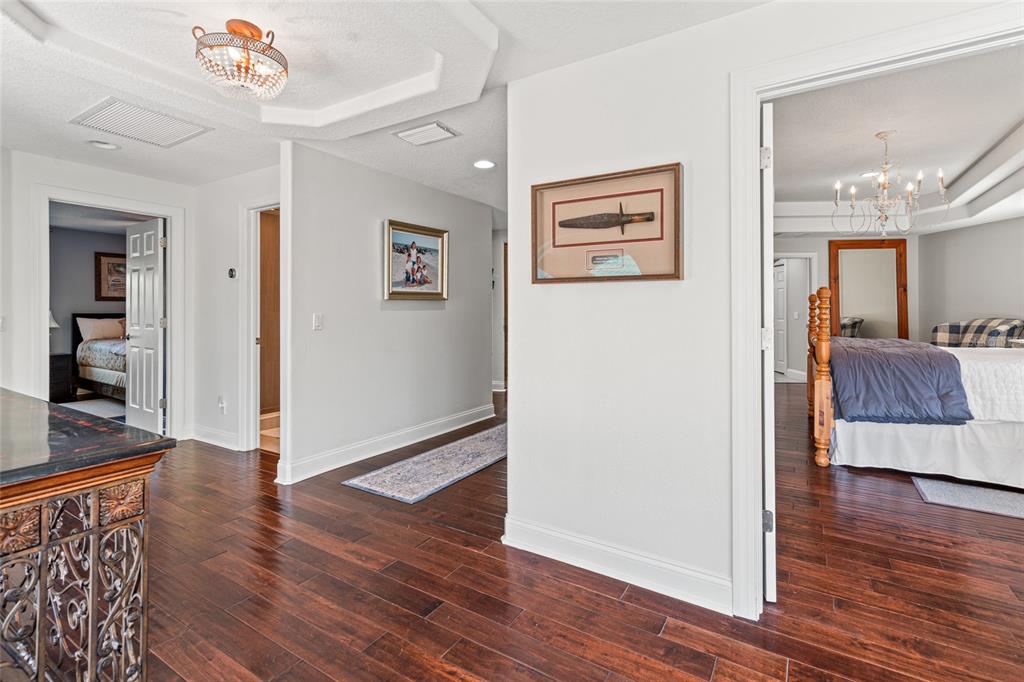 6315 Marbella Boulevard Apollo Beach, FL 33572 - Photo 27 of 83 a view of a hallway with wooden floor and a living room
