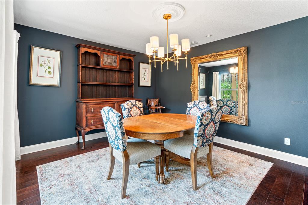 6315 Marbella Boulevard Apollo Beach, FL 33572 - Photo 6 of 83 a view of a dining room with furniture and wooden floor