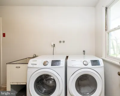 a view of storage and utility room with washer and dryer