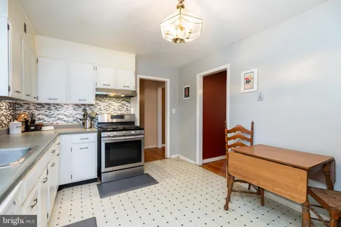 a kitchen with a stove a sink and a refrigerator
