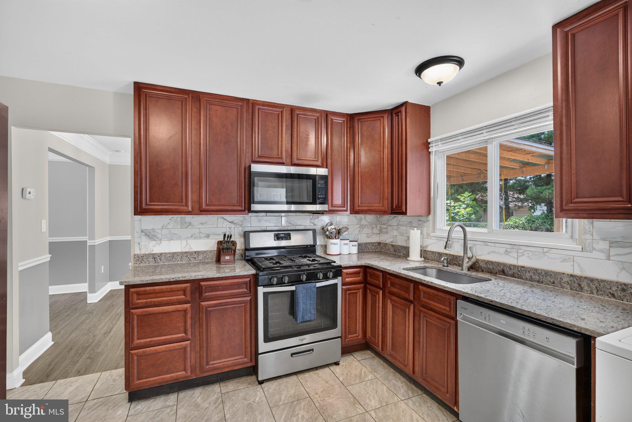 2106 North Rolling Road Windsor Mill, MD 21244 - Photo 9 of 24 Modern kitchen with rich wood cabinetry.