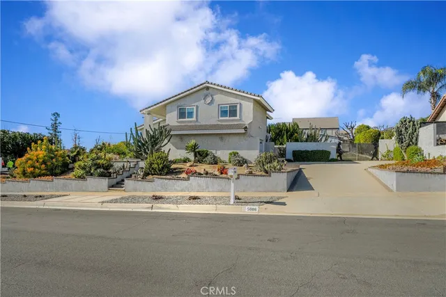 a front view of a house with a yard and a garage