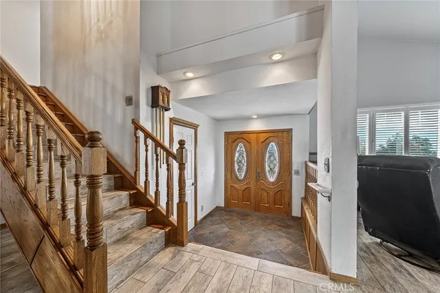 a kitchen with stainless steel appliances granite countertop a sink a stove cabinets and a dining table