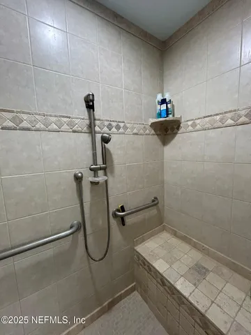a bathroom with a granite countertop toilet a sink and a mirror