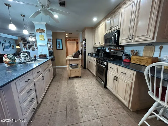 a view of a livingroom with wooden floor and a kitchen