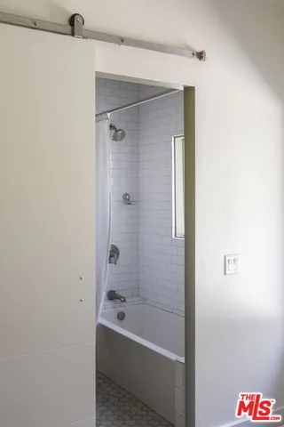 a bathroom with a bathtub and a shower