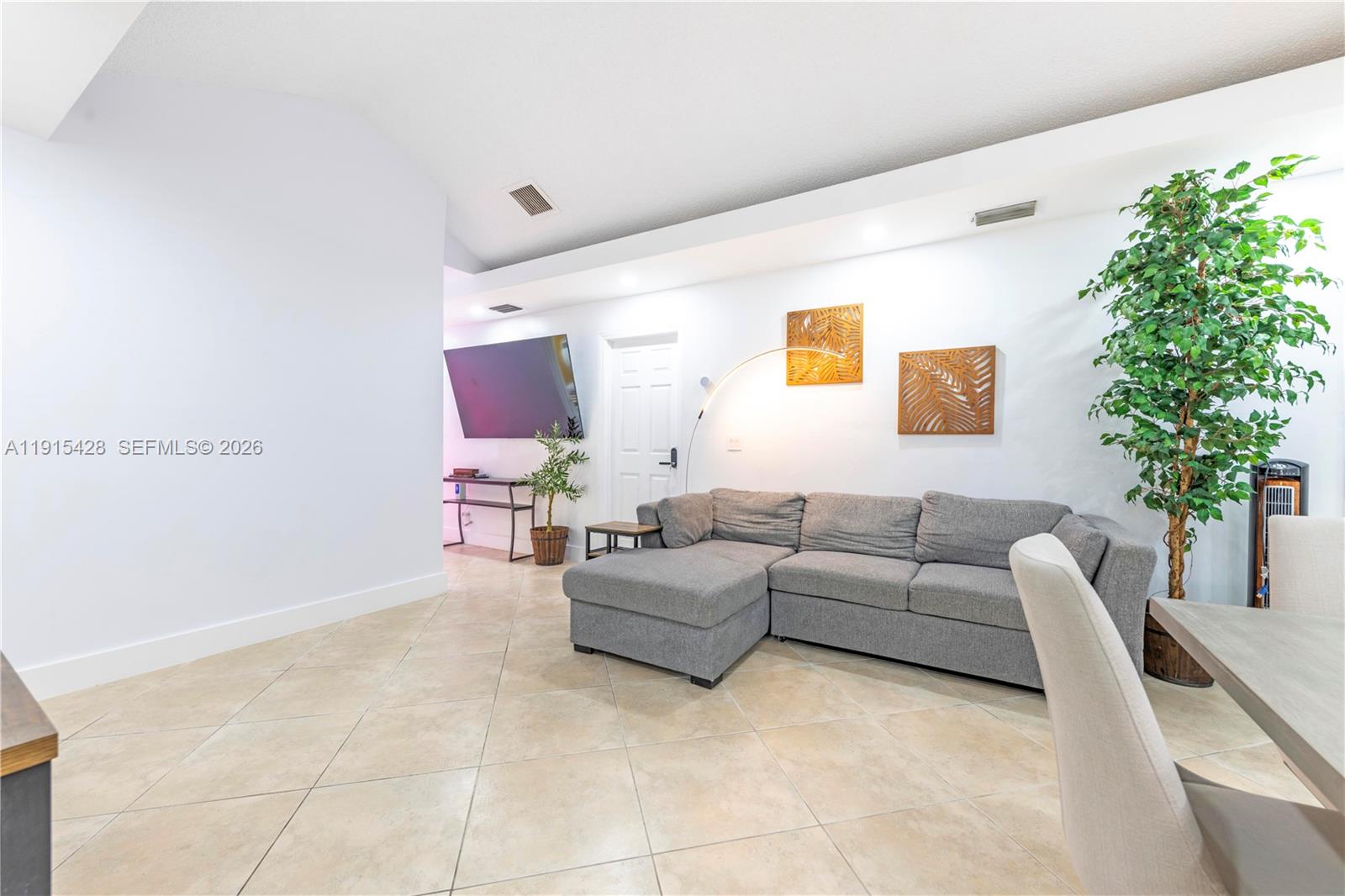 314 Southeast 3rd Street Dania Beach, FL 33004 - Photo 11 of 26 a living room with furniture and a potted plant