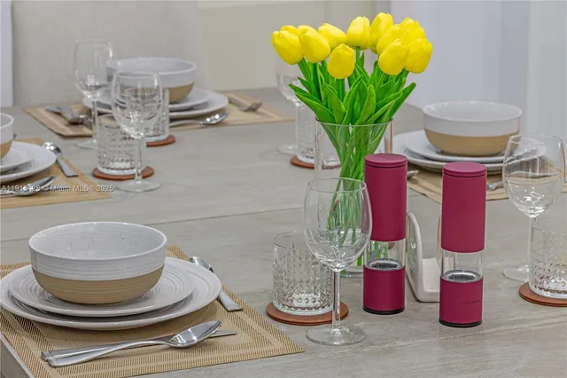 a vase of flowers sitting on a dining table