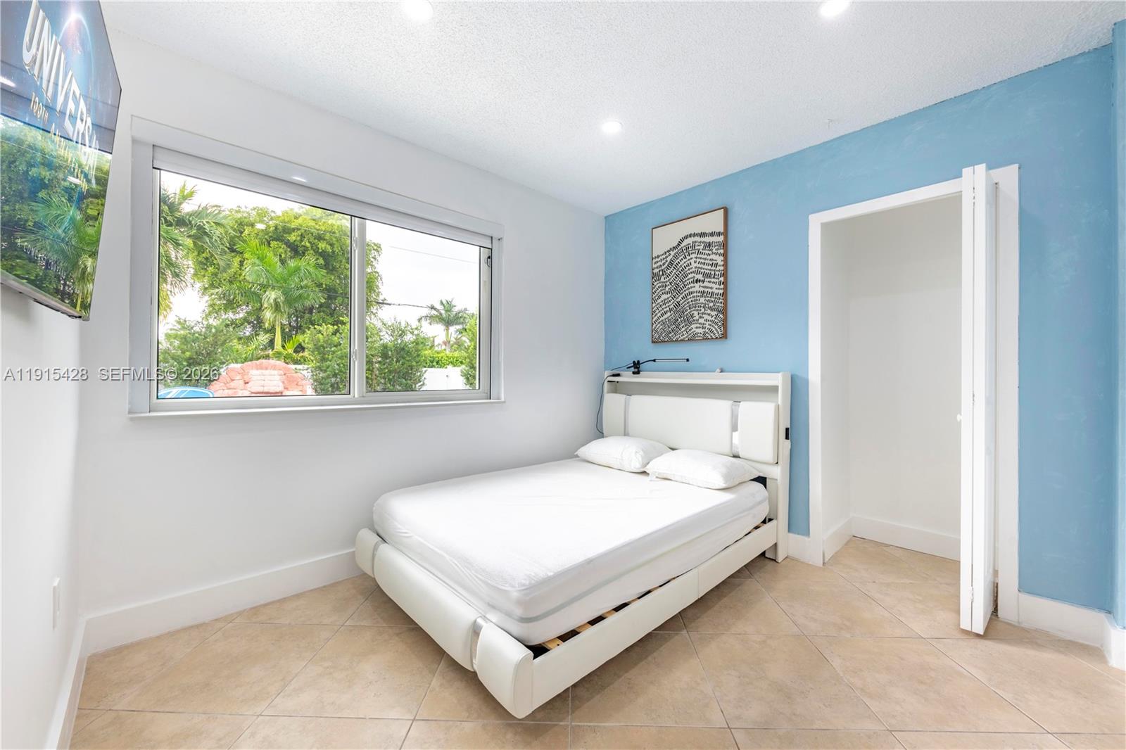 314 Southeast 3rd Street Dania Beach, FL 33004 - Photo 13 of 26 a bedroom with a bed and window