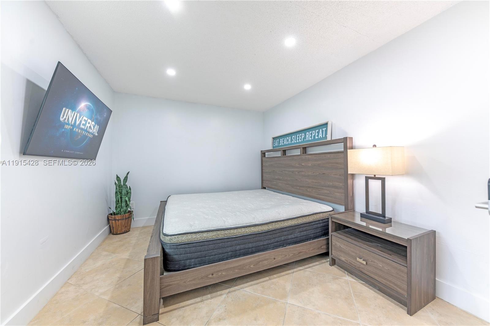 314 Southeast 3rd Street Dania Beach, FL 33004 - Photo 18 of 26 a bed room with a bed and a night stand