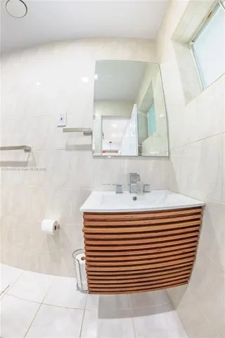 a bathroom with a sink a mirror and a shower