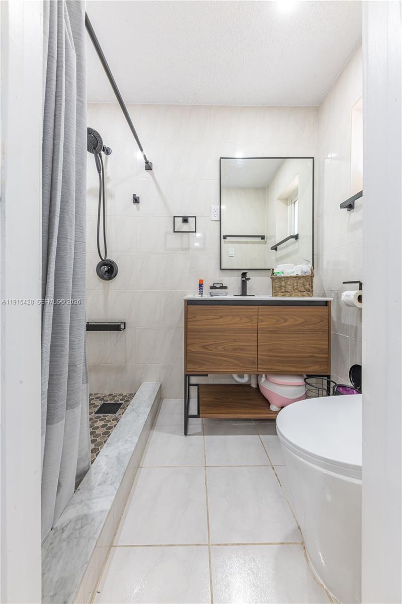 314 Southeast 3rd Street Dania Beach, FL 33004 - Photo 20 of 26 a bathroom with a sink a toilet and shower