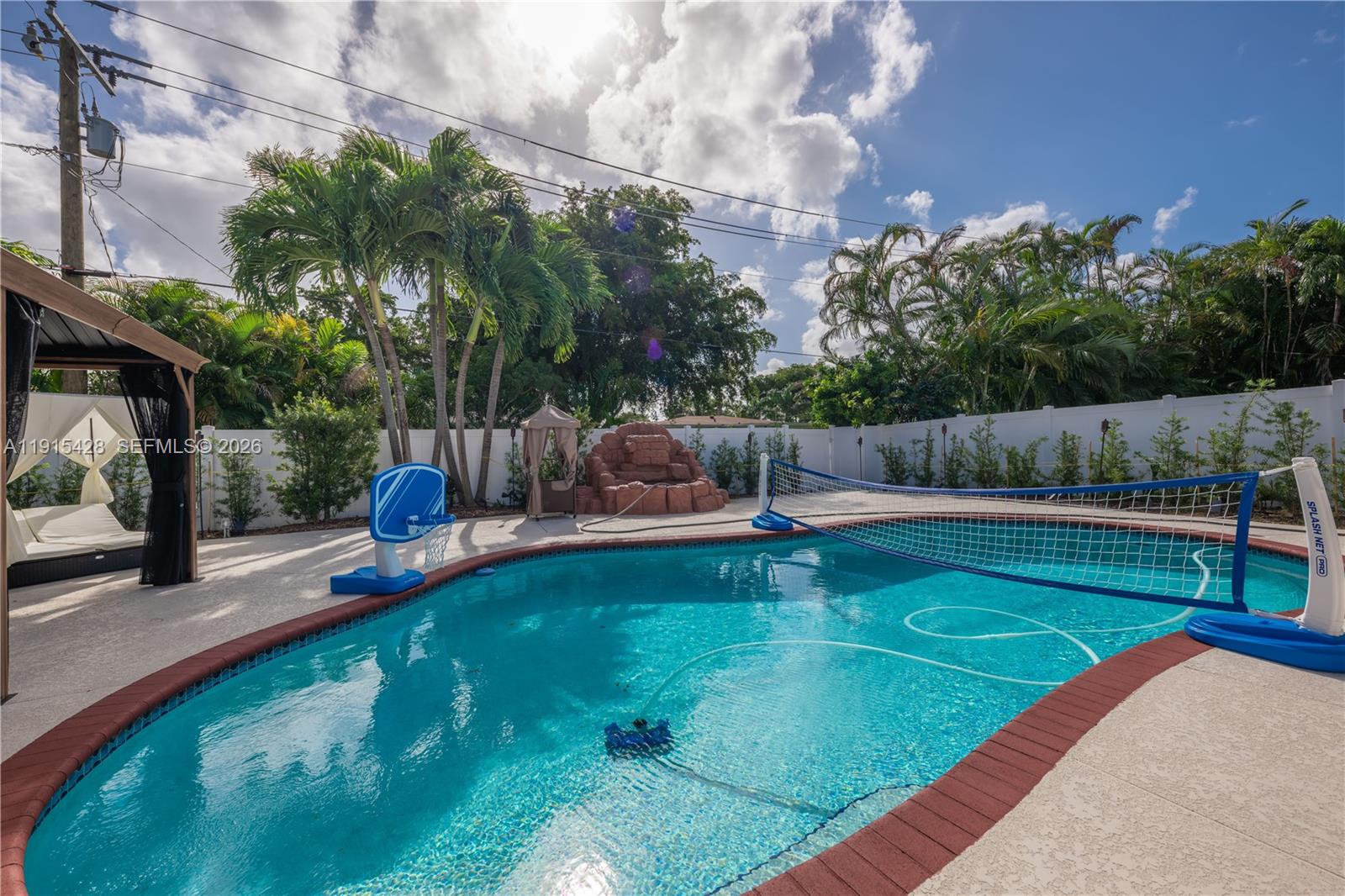 314 Southeast 3rd Street Dania Beach, FL 33004 - Photo 2 of 26 a swimming pool with wooden fence